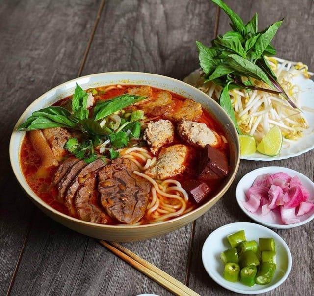 Bun Bo Hue Is Served With Herbs And Sprouts