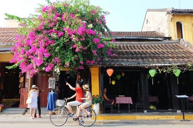 The couple is cycling in Hoi An's Old Town